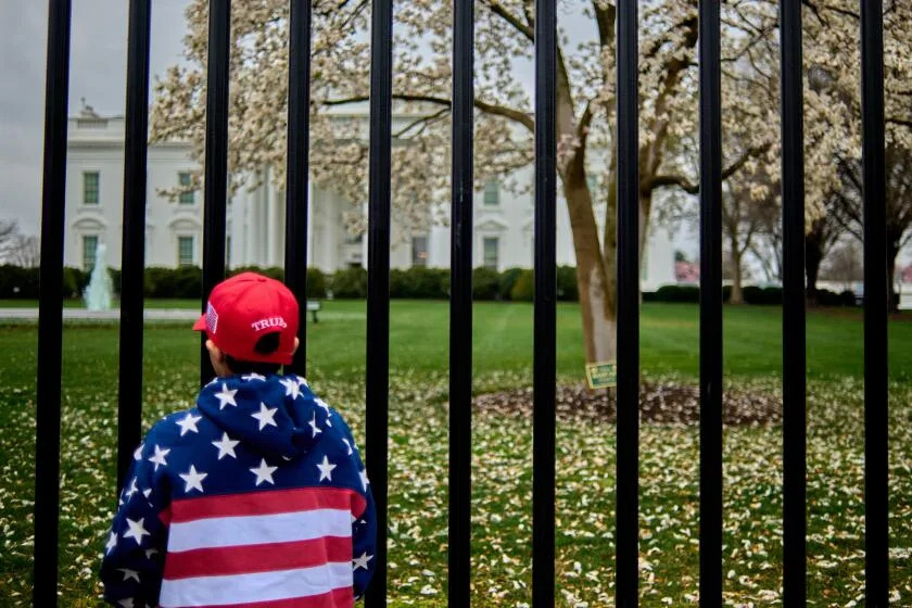 A young child and support of Donald Trump stands outside the White House in Washington D.C., US, Monday, March 24, 2025. (Photo by Dominic Gwinn / Middle East Images / Middle East Images via AFP) (Photo by DOMINIC GWINN/Middle East Images/AFP via Getty Images)