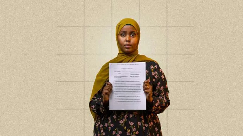 Hamdi Mohamud holds up her complaint against Officer Heather Weyker
