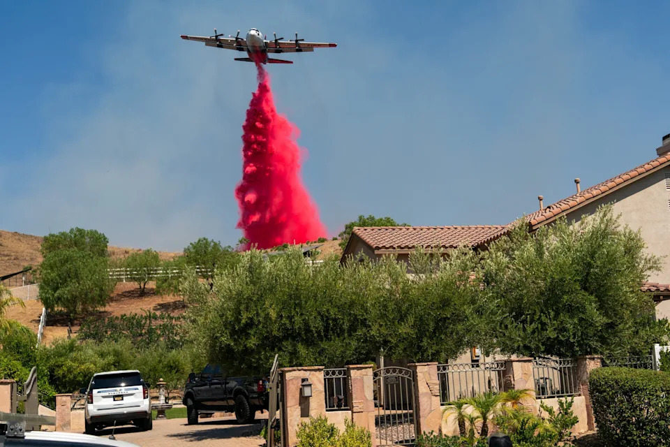 Flame retardant is dropped from an airplane during the Canyon Fire in Hasley Canyon, California, US, on Friday, Aug. 8, 2025