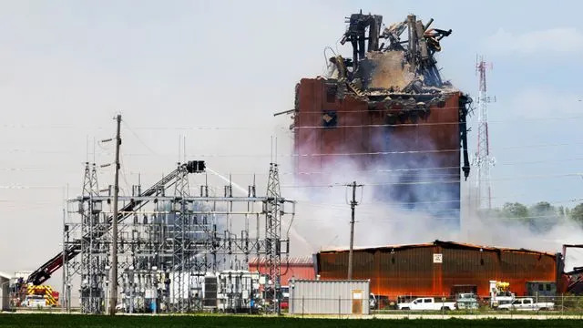 Chris Machian/Omaha World-Herald via AP Firefighters continue to battle the fire at the building in Fremont, Neb.