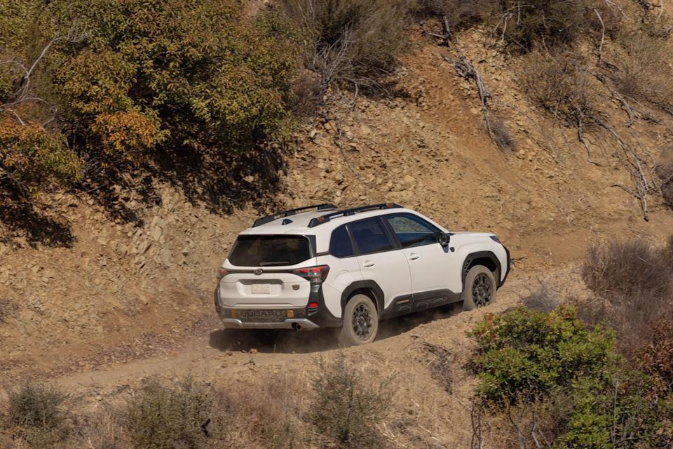 2026 subaru forester wilderness rear three quarter view on dusty off road trail