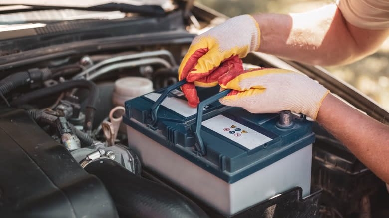 Man installing a new car battery