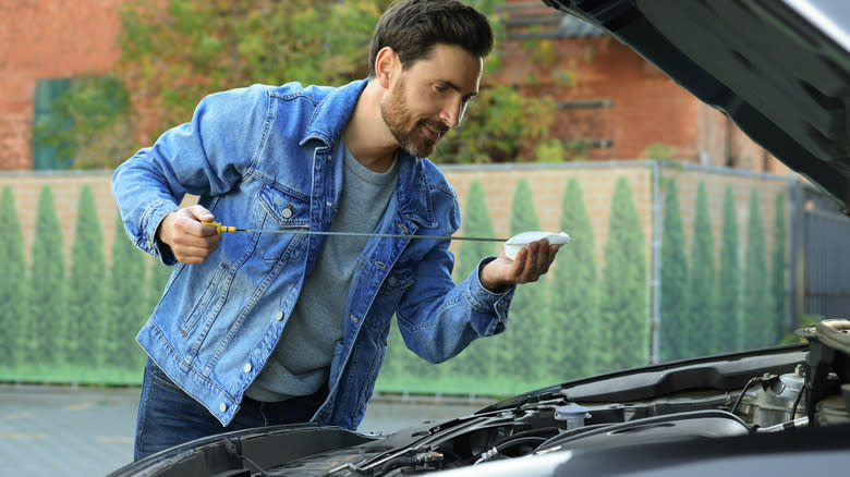 A man checking oil