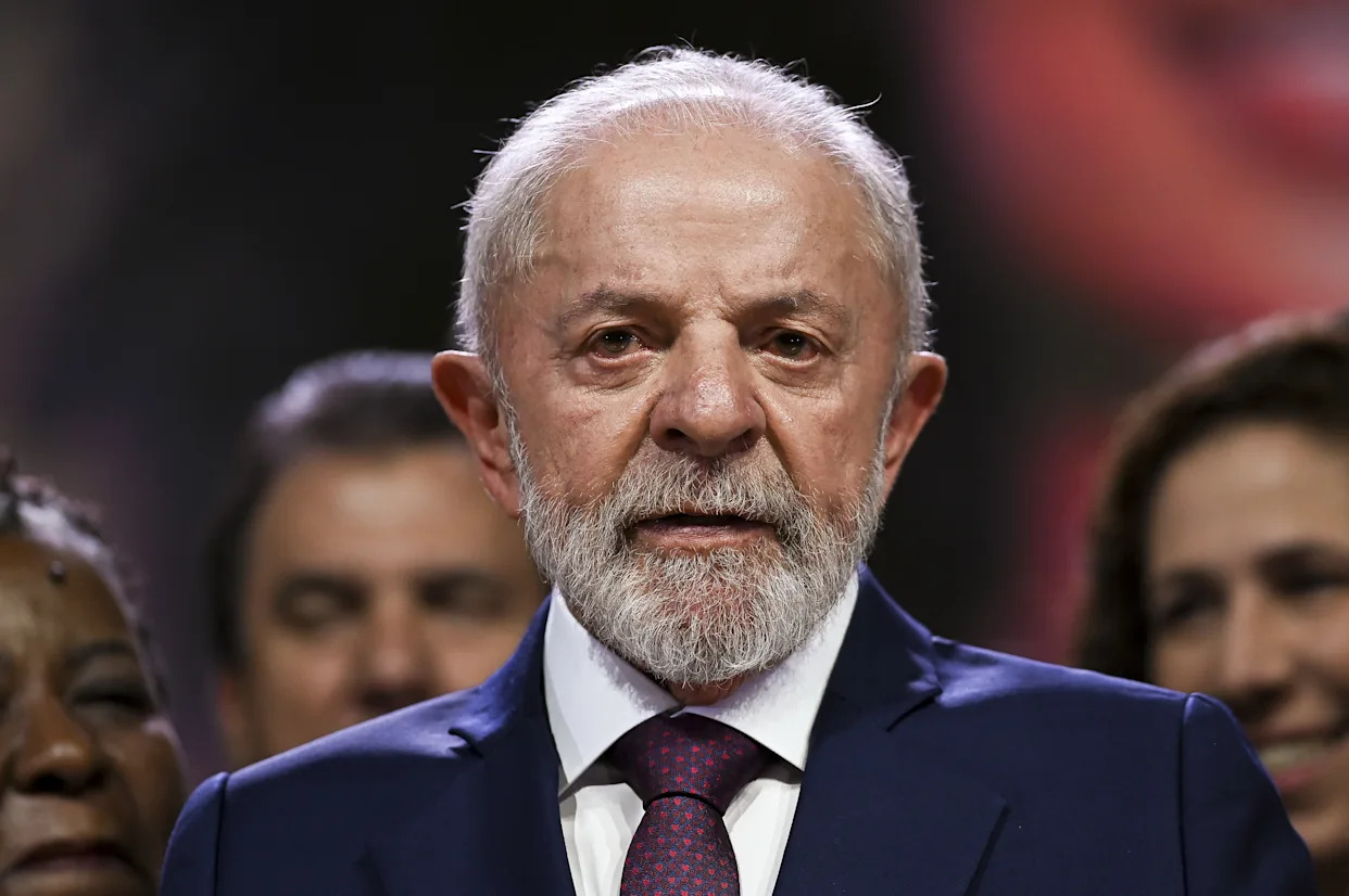 Brazilian President Lula da Silva, an older man with a white beard, wears a navy suit.