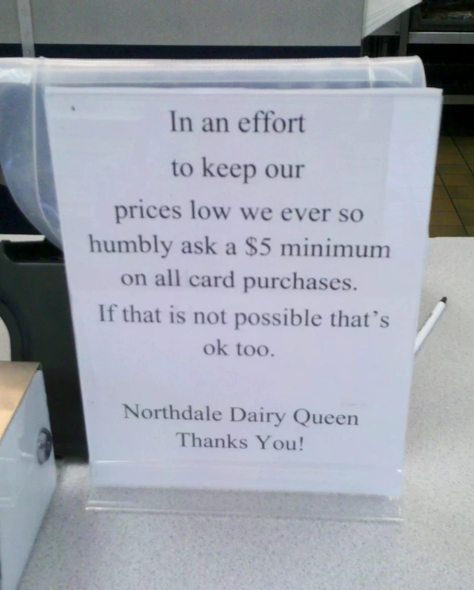 Sign at counter requesting a $5 minimum for card purchases, but states it's okay if not possible. From Northdale Dairy Queen