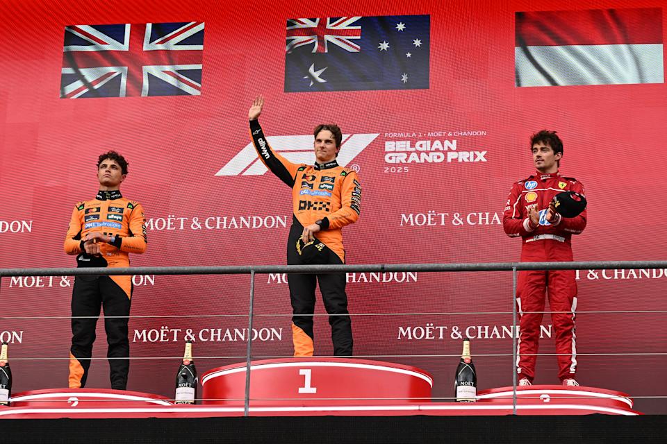 First placed McLaren's Australian driver Oscar Piastri C, second placed McLaren's British driver Lando Norris L and third placed Ferrari's Monegasque driver Charles Leclerc react during the awarding ceremony for the race of the Formula One Belgian Grand Prix at the Spa-Francorchamps circuit in Stavelot, Belgium, July 27, 2025. (Photo by Zhao Dingzhe/Xinhua via Getty Images)