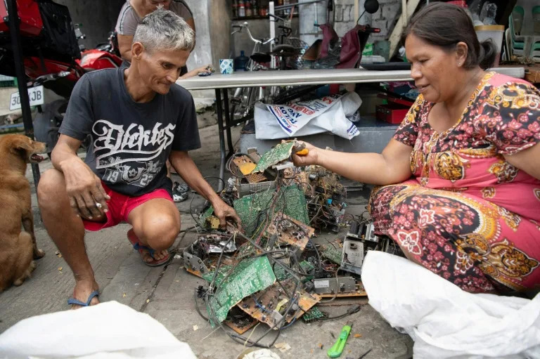 Dexter Barsigan and his wife Rosalie Sedantes strip parts from discarded electronic equipment in Manila. Barsigan has spent the past 13 years making a living with his bare hands and a pair of pliers, stripping scrapped laptops metal he can sell to junk shops (Ted ALJIBE)