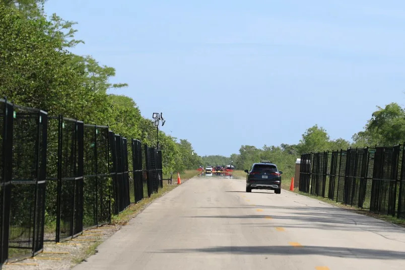 OCHOPEE, FLORIDA – JULY 12: A vehicle carrying Rep. Maxwell Frost (D-FL) drives along the entrance road to “Alligator Alcatraz” at the Dade-Collier Training and Transition Airport on July 12, 2025, in Ochopee, Florida. Members of Congress were given their first visit to the new state-managed immigration detention facility in the Florida Everglades that officials have named “Alligator Alcatraz.” (Photo by Joe Raedle/Getty Images)