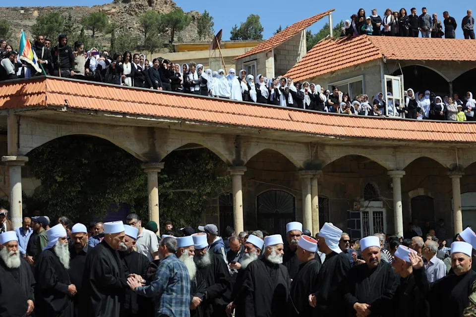 Members of Syria's Druze community attend a funeral for its members who were killed in recent sectarian clashes