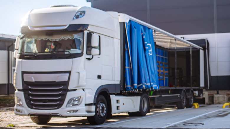 A cab-over truck at a warehouse