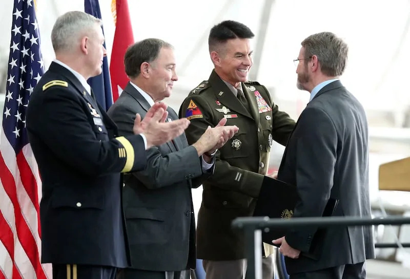 Utah National Guard Brig. Gen. Michael Turley, left, and Gov. Gary Herbert watch as Maj. Gen. Jeff Burton, Utah National Guard adjutant general, shakes hands with Barry McLerran, representing Sen. Mitt Romney, during a retirement ceremony for Burton at the Roland R. Wright Air National Guard Base in Salt Lake City on Thursday, Nov. 7, 2019. Turley will replace Burton as adjutant general. | Kristin Murphy, Deseret News