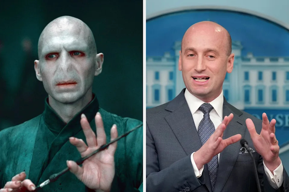 A person in a wizard costume holding a wand alongside a person in a suit speaking at a podium