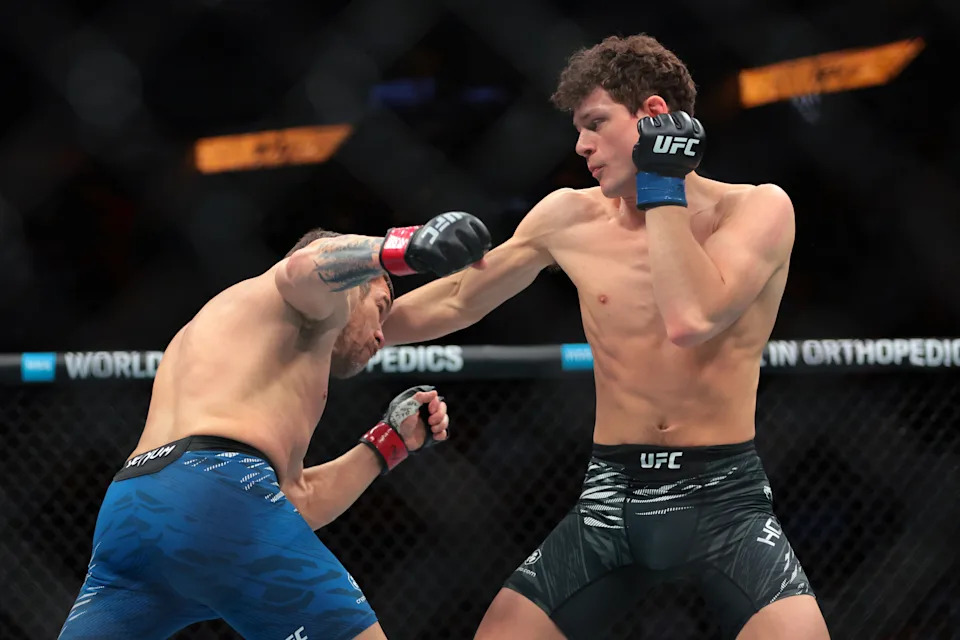 Apr 12, 2025; Miami, Florida, UNITED STATES; Jim Miller (red gloves) fights against Chase Hooper (blue gloves) during UFC 314 at Kaseya Center. Mandatory Credit: Sam Navarro-Imagn Images