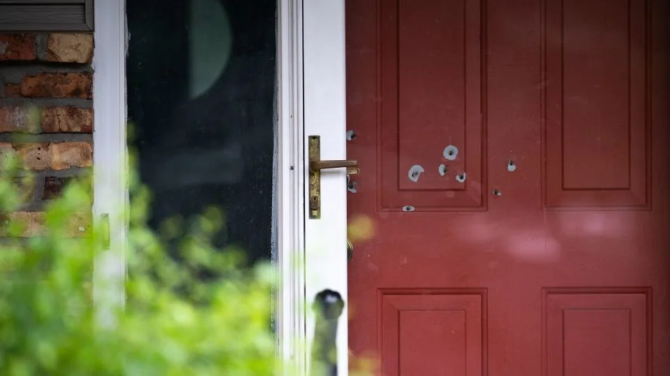 Bullet holes are seen in the door outside the home of State Sen. John Hoffman in Champlin, Minnesota, on June 15. - Stephen Maturen/Getty Images