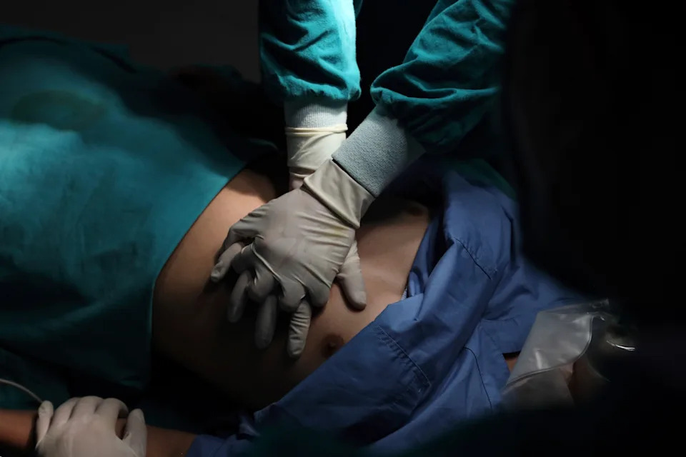 Medical professionals performing chest compressions on a patient in an emergency setting