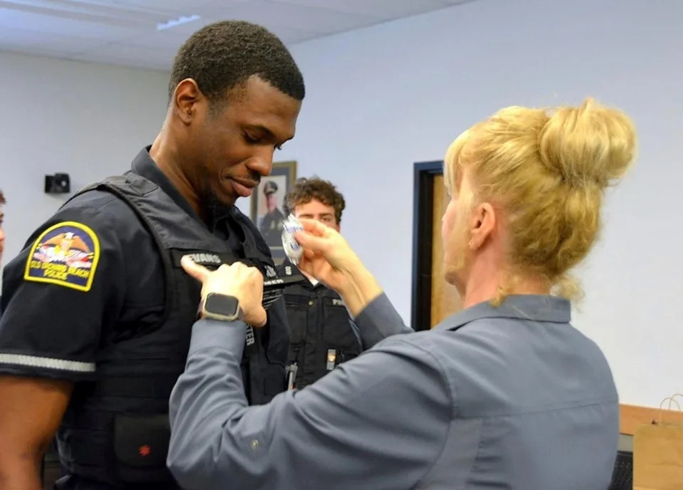 Officer Jon Luke Evans receives his police badge. DHS’s E-Verify system verified he was authorized to work in the U.S., the Old Orchard Beach Police Department said, while DHS says the police department had a ‘reckless reliance’ on the system (Old Orchard Beach Police Department via AP)