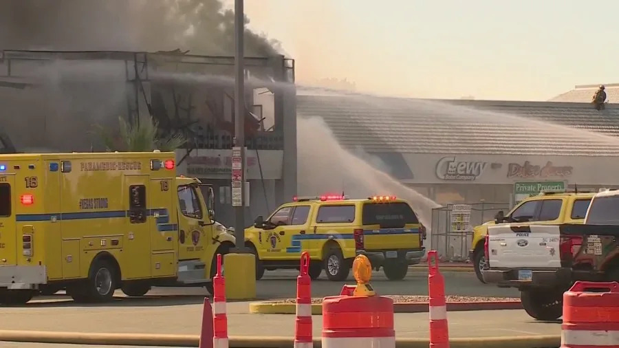 Clark County fire crews battle a large blaze at a business complex across the street from the UNLV campus on Maryland Parkway, near Tropicana Avenue on July 25, 2025. (KLAS)