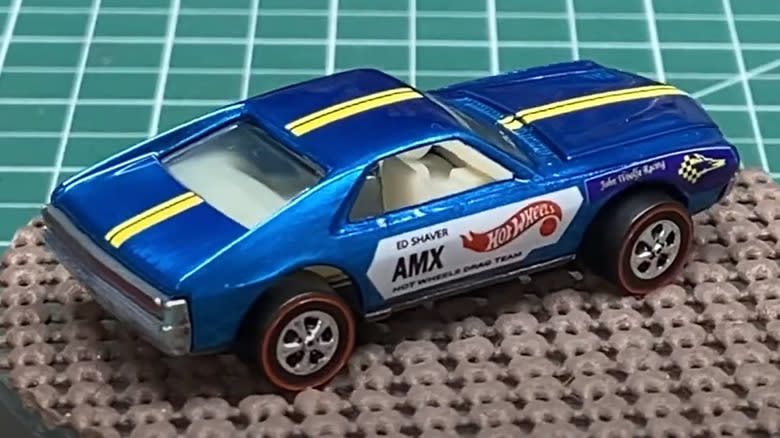 A display of a replica Ed Shave AMX Hot Wheels car with decals.