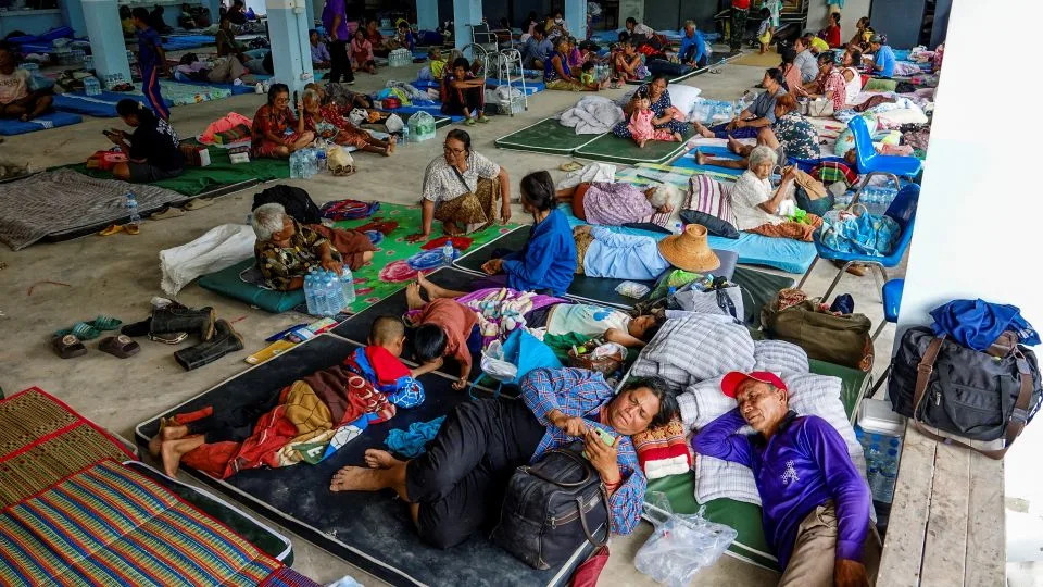 People rest at a shelter in Thailand's Surin province on July 24, after clashes broke out along the disputed Thai-Cambodian border. - Pansira Kaewplung/Reuters