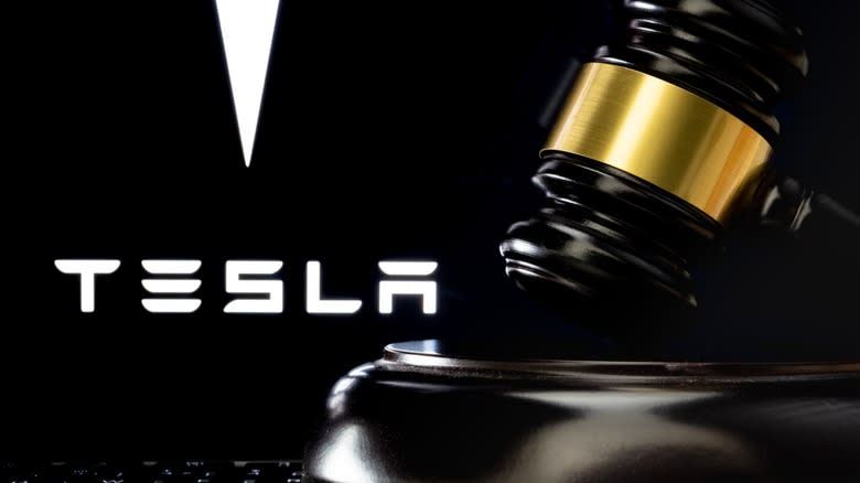 Judges gavel with Tesla logo in background