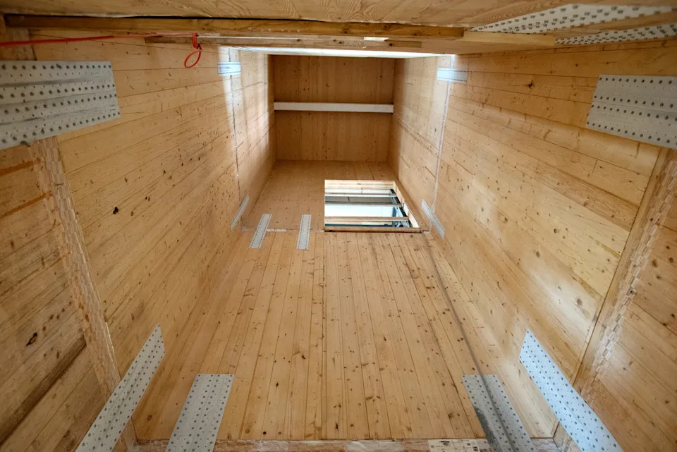an upward view of cross-laminated-timber shear walls used in an elevator shaft.