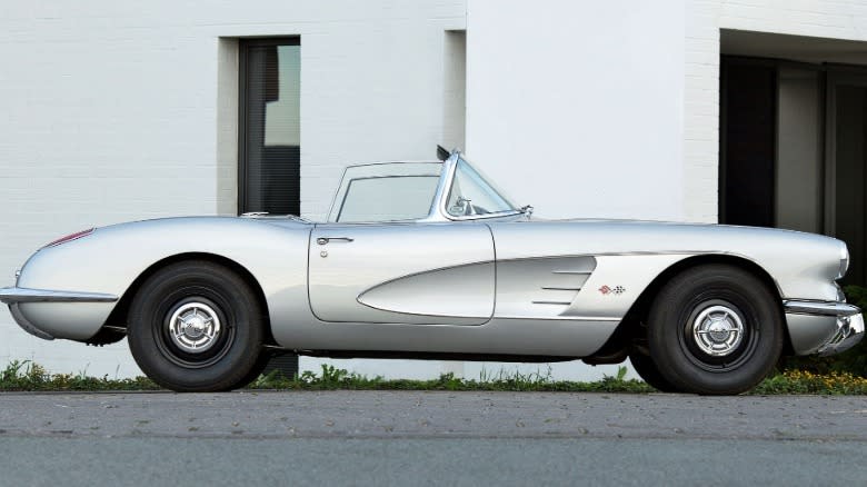 A side view of the C1 Corvette convertible in Inca Silver that inspired the Quail Silver Limited Edition ZR1X parked in front of a white building