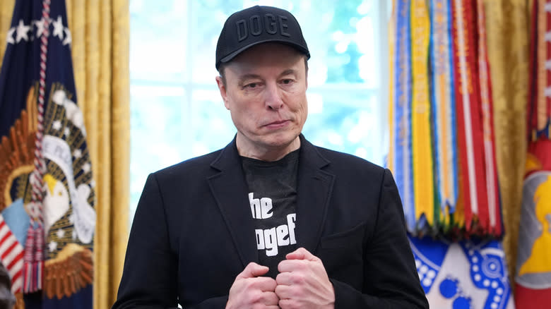 Elon Musk listens as U.S. President Donald Trump speaks to reporters in the Oval Office of the White House on May 30, 2025 in Washington, DC.