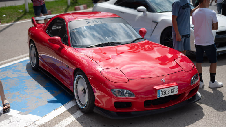 Top view of a spectacular Mazda Rx-7 rotary engine at a car meeting, tuned in Japanese style for touge racing, Impul Silhouette tires