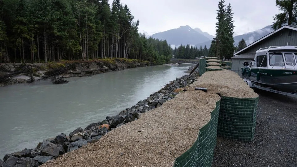 HESCO flood barriers, to protect property against glacial outburst flooding, separate a residential area from the Mendenhall River, on August 3, in Juneau, Alaska. - Marc Lester/Anchorage Daily News/AP