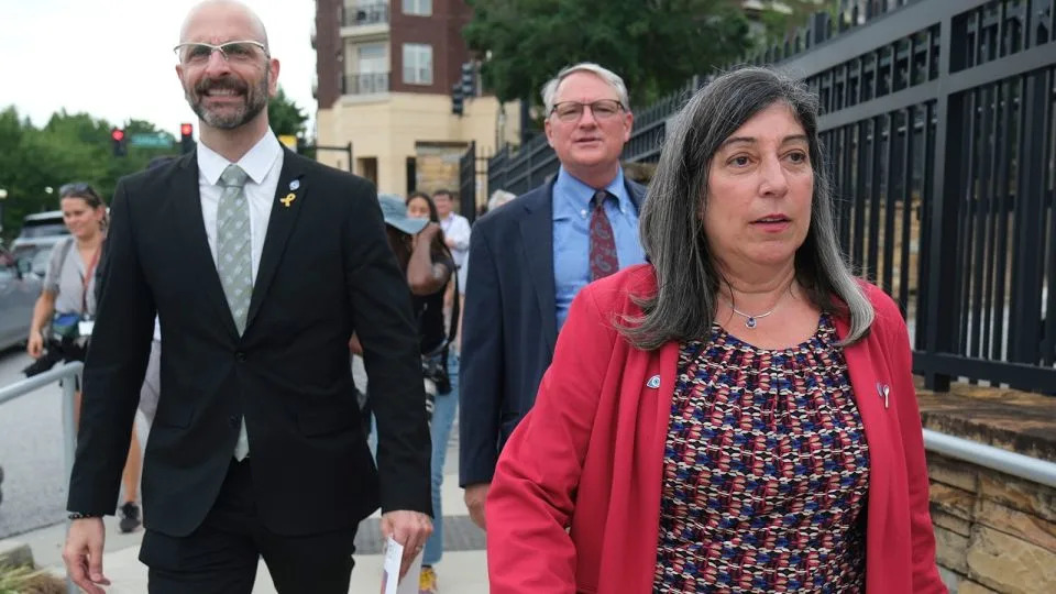 Dr. Debra Houry, right, Dr. Demetre Daskalakis, left, and Dr. Daniel Jernigan gather as workers and supporters rally outside the the Centers for Disease Control and Prevention outside the CDC headquarters, Thursday, August 28, in Atlanta. - Ben Gray/AP