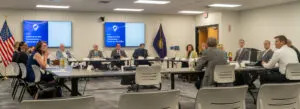  Nebraska’s new School Financing Review Commission meets for the first time. Gov. Jim Pillen, front-center, addresses the group. Aug. 12, 2025. (Zach Wendling/Nebraska Examiner)