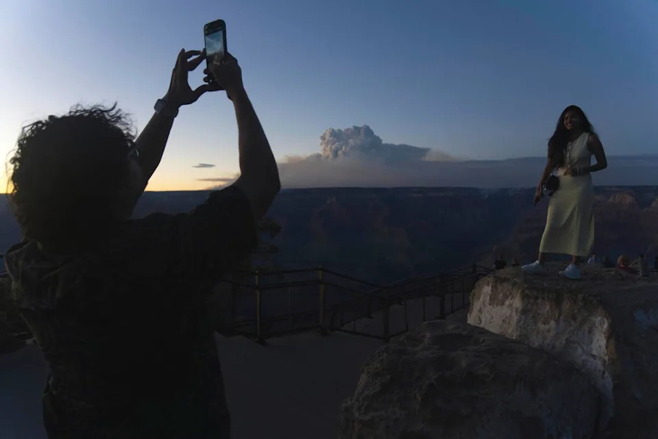 Smoke and a pyrocumulus cloud rise at sunset from the Dragon Bravo fire at the Grand Canyon