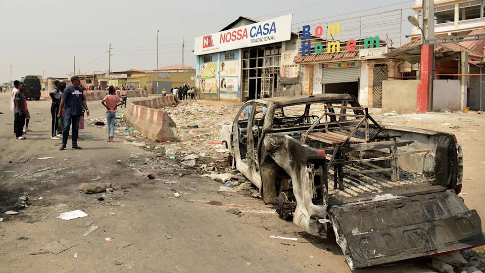 A burned vehicle in the street in Angola