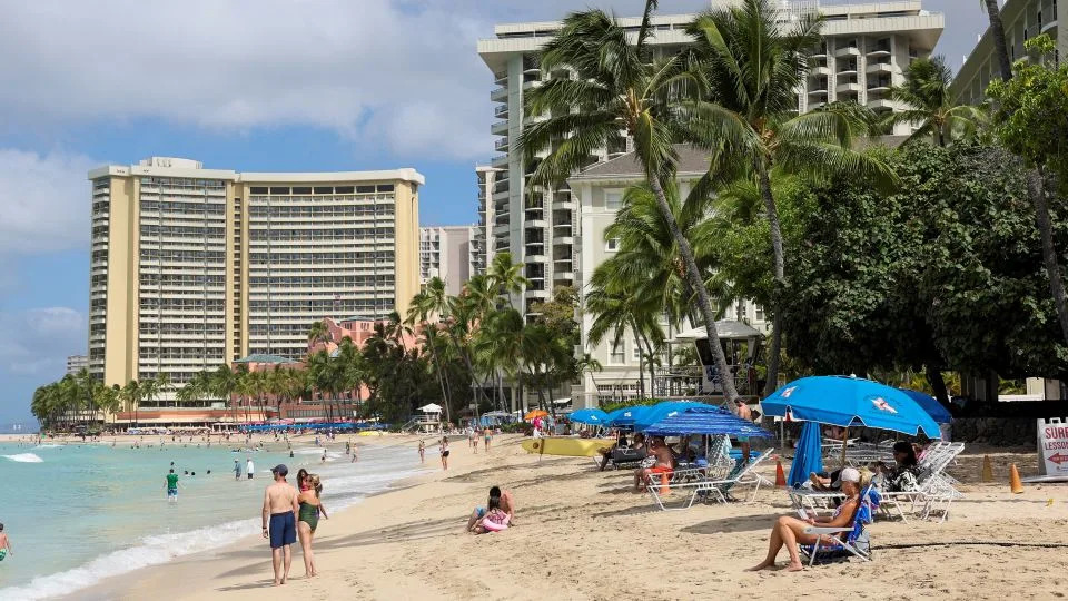 Beachgoers gather in Waikiki after authorities downgraded earlier tsunami warnings following an earthquake off Russia’s Kamchatka Peninsula. - Marco Garcia/Reuters