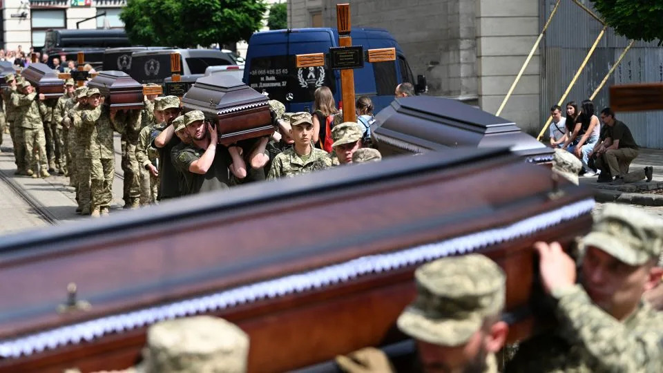 Ukrainian soldiers carry the coffins of twelve Ukrainian servicemen and prisoners of war who died being held in Russian captivity during a funeral ceremony in Lviv, western Ukraine, on July 25. - Yuriy Dyachyshyn/AFP/Getty Images
