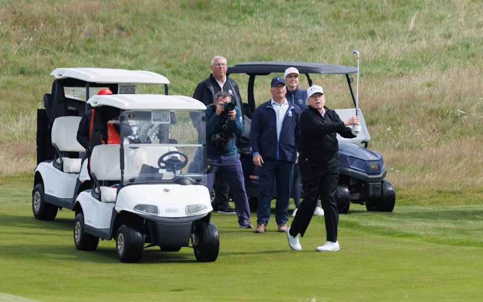 Mr Trump plays a shot on his Turnberry course