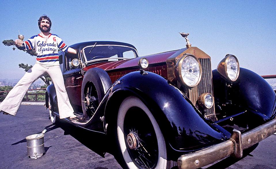 keith moon, the who's celebrated drummer standing on the running board of his classic rolls royce car on mulholland drive in the hollywood hills in los angeles, california, june 1976.