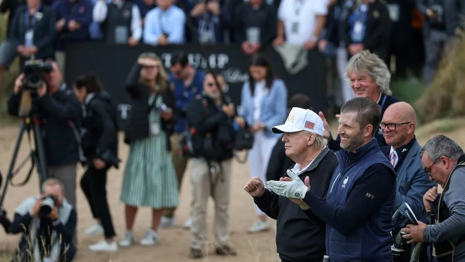 President Donald Trump stands next to Eric Trump as he opens his new golf course at his Trump International Golf links resort in Balmedie, Scotland, on July 29, 2025. - Jeff J Mitchell/Getty Images/File
