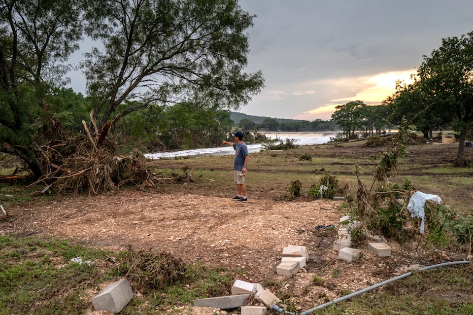 a man points while standing on an empty lot
