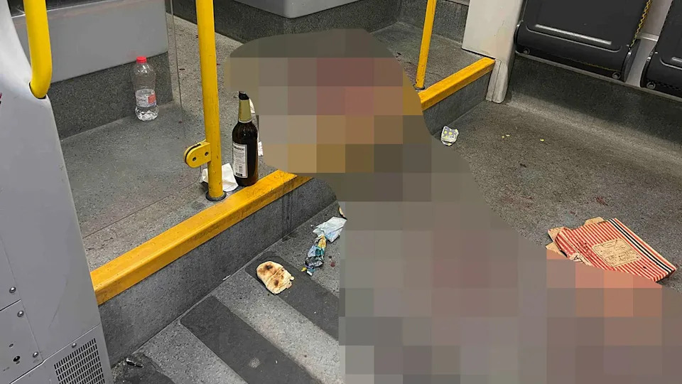 A beer bottle sits next to blood on the floor of a German tram where an American tourist was stabbed.
