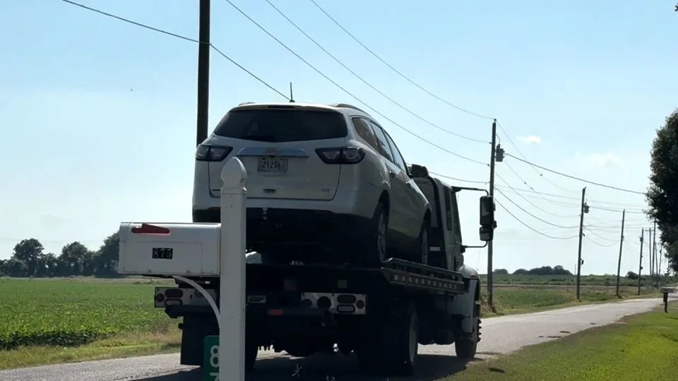 A car is removed from near where the bodies were found in Lake County, Tennesee. - WHBQ