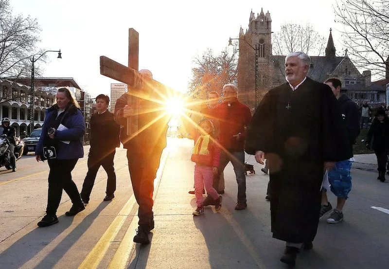 Alex Bury, left, Juliana Snow and Rev. Eun-sang Lee of the First United Methodist Church carry the cross as it leaves the First Presbyterian Church during the Good Friday Procession of the Cross in Salt Lake City, Friday, March 25, 2016. At right is Rev M
