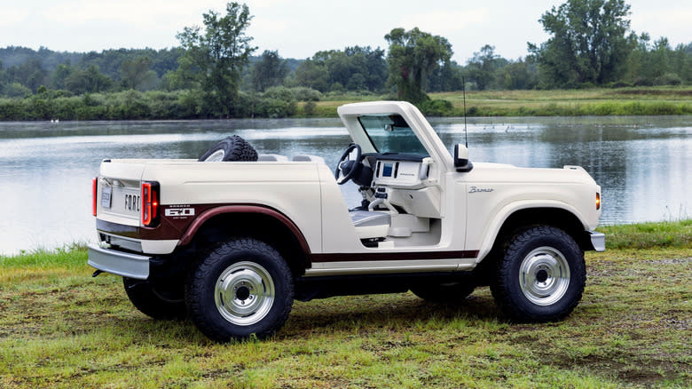 rear three-quarters shot of the white Bronco Roadster Concept parked on grass in front of a lake