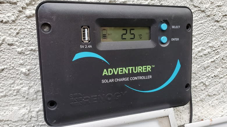 A solar charge controller is mounted to a wall.