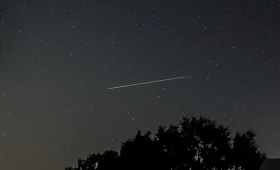 A bright Perseid meteor appears Aug. 21, 2021, in the northern sky during the Perseid meteor shower in North Carolina.