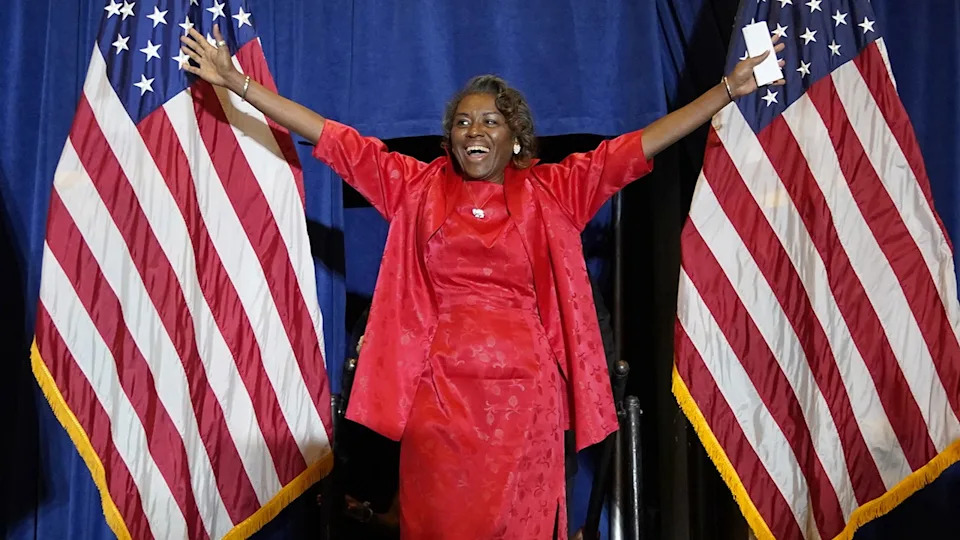 Winsome Sears with her hands in the air