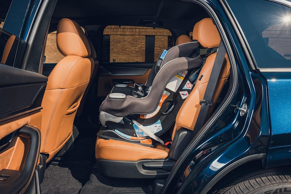 2024 mazda cx 90 with front facing convertible child's seat in second row behind driver