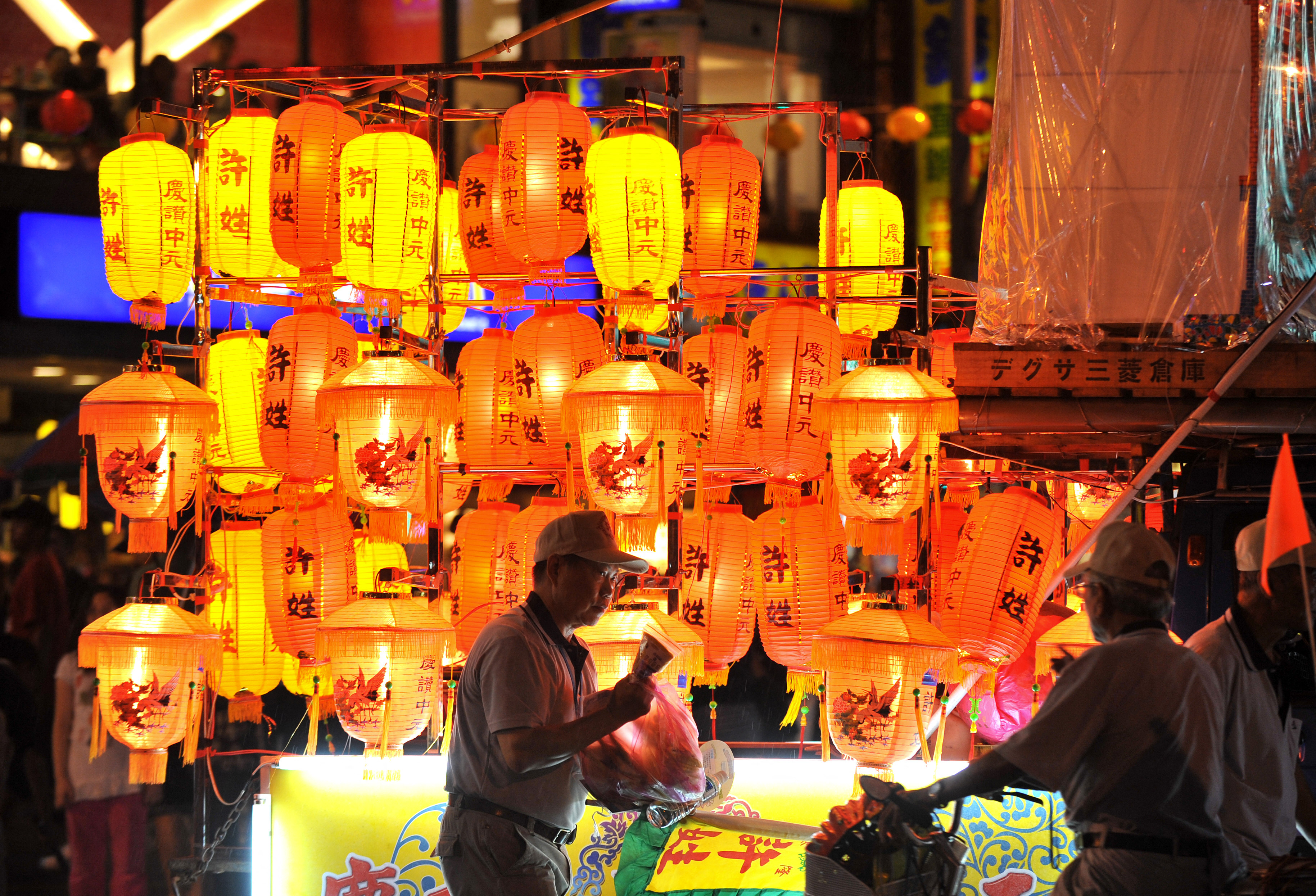 Devotees decorate a cart with lanterns during a parade in Taiwan's northern Keelung city on August 23, 2010, a day before the annual Ghost Day on the fifthteen day of the seventh month in the Chinese lunar calendar. Taoists and Buddhists pay homage to the spirits by preparing ritualistic food offerings, burning incense, and burning joss paper during the month. AFP PHOTO/PATRICK LIN (Photo by PATRICK LIN / AFP) (Photo by PATRICK LIN/AFP via Getty Images)          