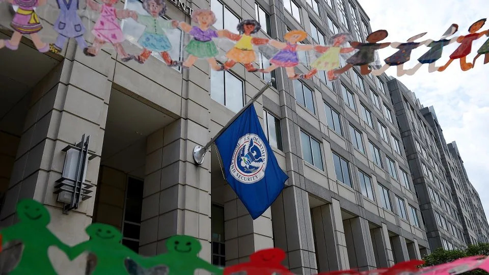In this July 2020 photo, paper dolls are held by demonstrators protesting outside the Immigration and Customs Enforcement headquarters in Washington, DC. - Olivier Douliery/AFP/Getty Images