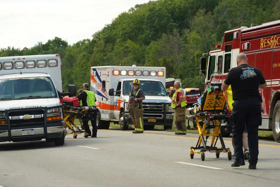 Rescue personnel work the scene of a tour bus that crashed and rolled over on the New York State Thruway near Pembroke, N.Y., Friday, Aug. 22, 2025. (Libby March/The Buffalo News via AP)